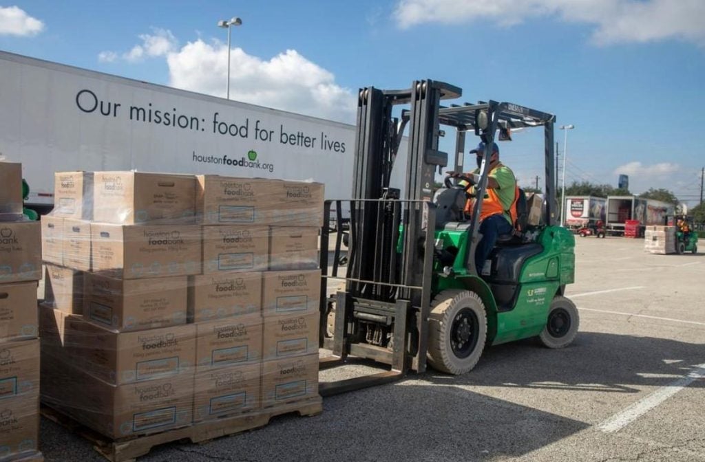 image of forklift operator lifting boxes of donated food