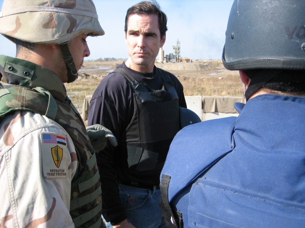 ABC NEWS - Bob Woodruff (center) pictured with protective clothing just moments prior to Iraq bombing.   (CREDIT:  ABC NEWS/ VINNIE MALHOTRA) Jan. 29, 2006 "World News Tonight" anchor, Bob Woodruff and his camera man, Doug Vogt, are both in serious condition after they were hit by an improvised explosive device in Taji, Iraq, today. Woodruff, Vogt and their four-man team were traveling in a convoy with the Iraqi army. They were in a mechanized vehicle when the explosive went off. The exposion was followed by small arms fire. Both men suffered head injuries.