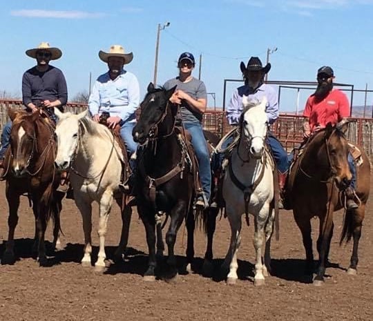 Five WTCG staffers pose on horseback. 